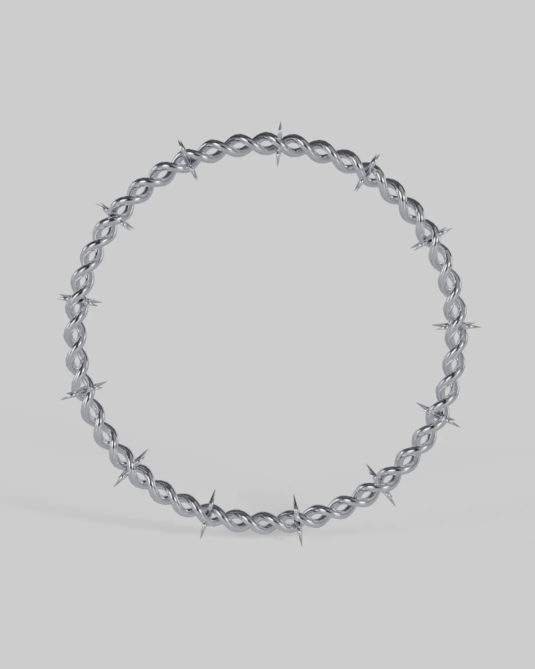 A twisted chrome barbed-wire choker closed into a ring.