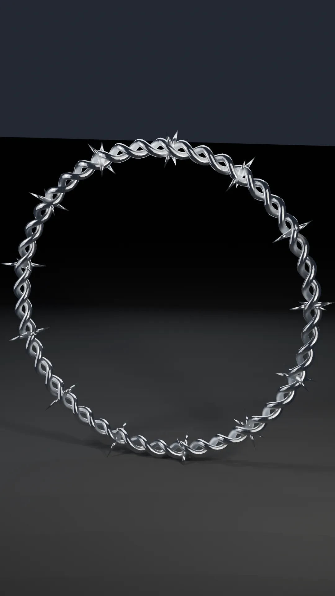 A twisted chrome barbed-wire choker closed into a ring.