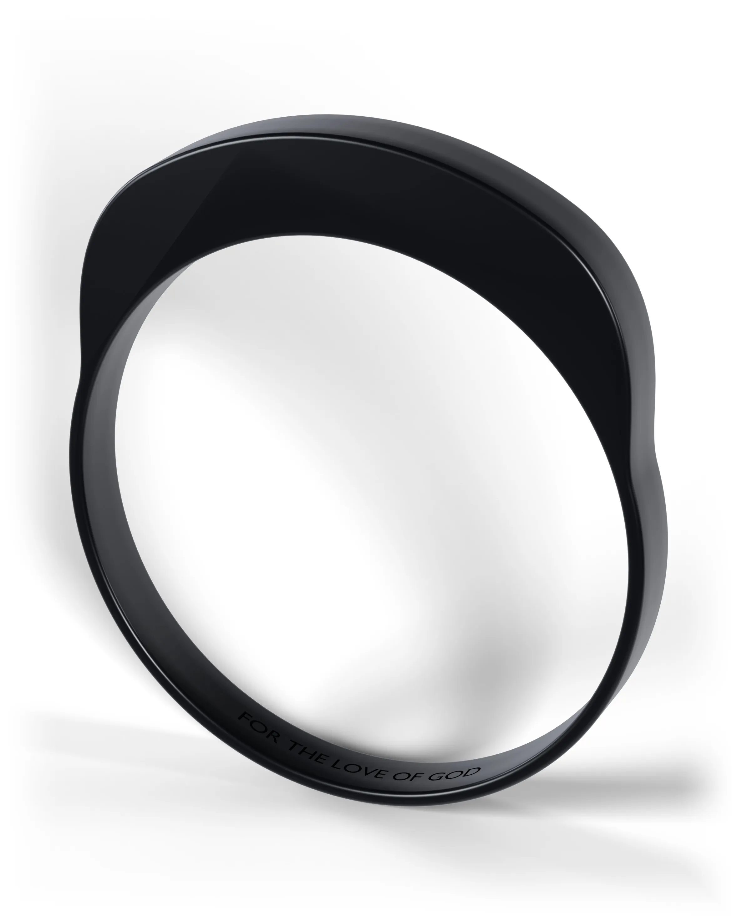 A black signet ring standing on edge, seen at an angle, the engraving cut into the inside of the band.