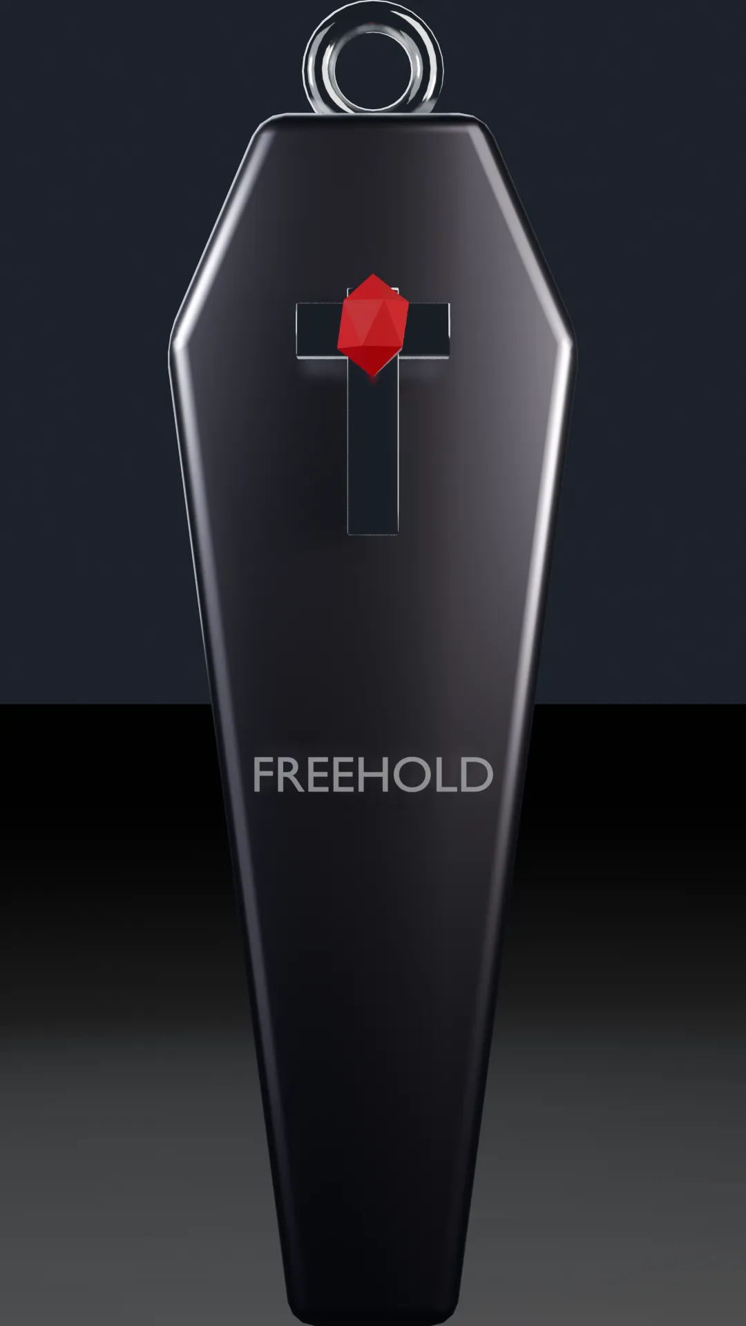 A polished chrome toe-pincher coffin sculpture with a chrome cross and a red gem, engraved FREEHOLD.