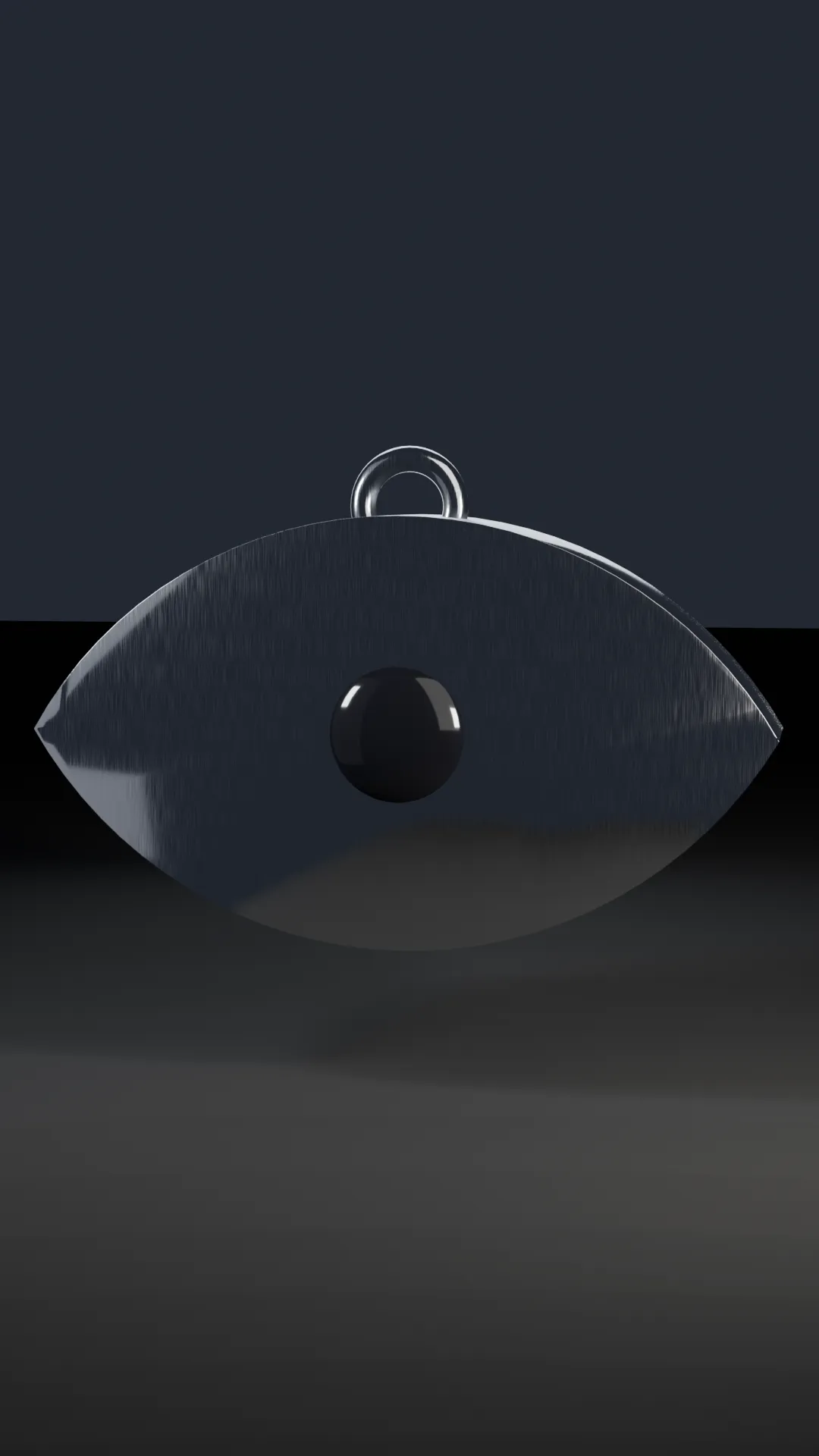 Chrome almond-shaped eye sculpture with an onyx pupil and engraved iris.